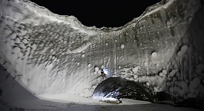 Ice cave at the bottom of a thermokarst funnel in Yakutia